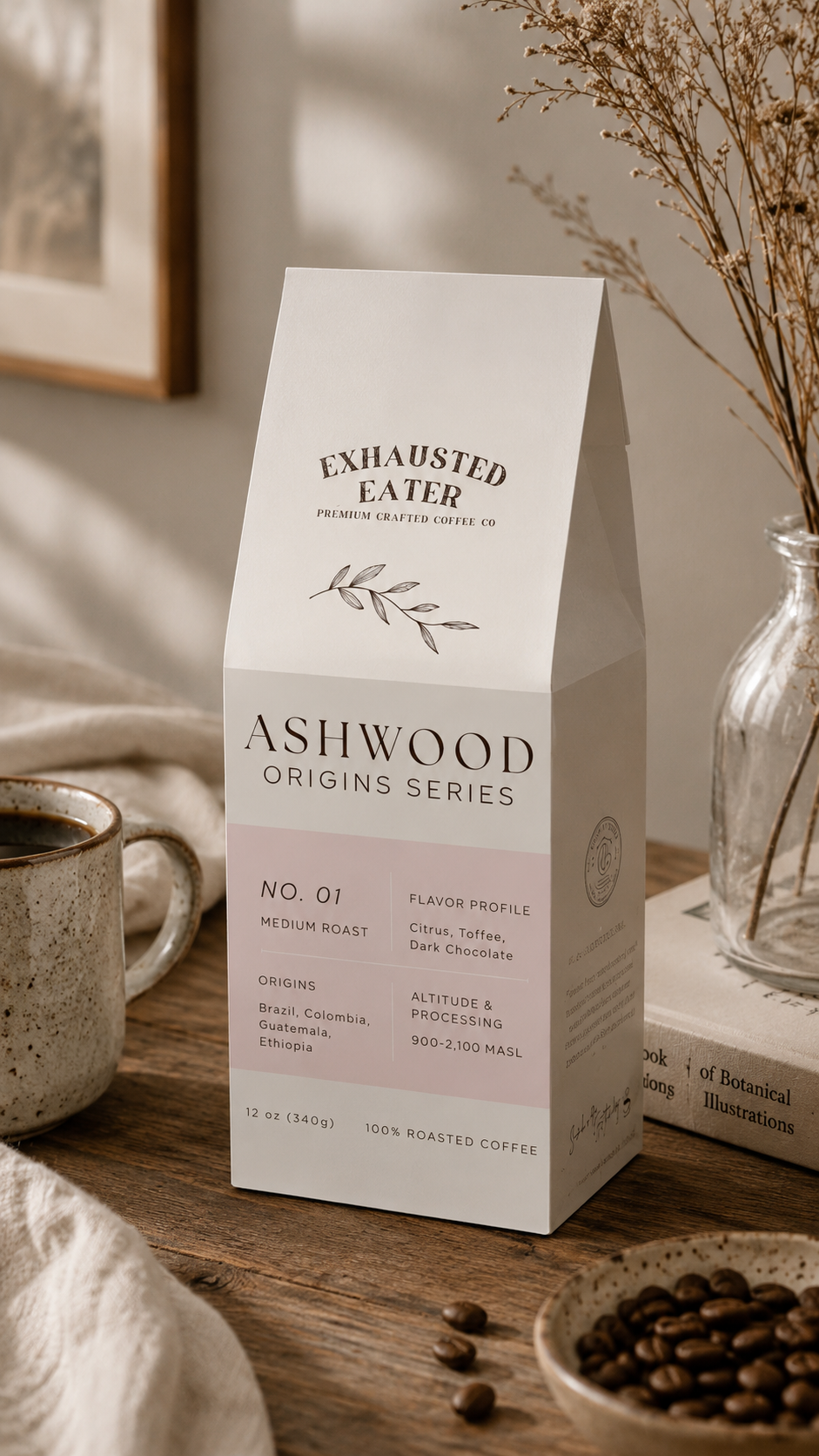 Box of Ashwood Origins Series coffee on a wooden table with a cup and beans.