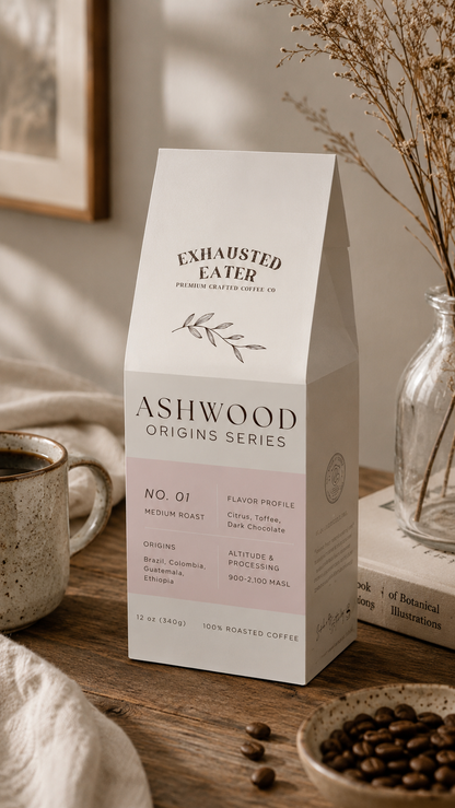 Box of Ashwood Origins Series coffee on a wooden table with a cup and beans.